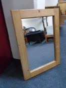 A bevel edged overmantel mirror in rustic pine frame.