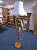 A beech standard lamp with shade