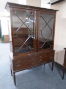 A mahogany Regency style double door glazed bookcase