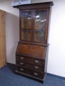 An Arts and Crafts bureau bookcase.