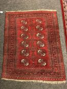 An Afghan Bokhara rug, 116cm by 95cm.