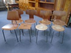 A set of four plywood dining chairs on metal legs together with a similar dining chair and three
