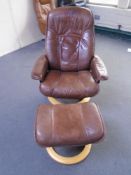 A Stressless brown leather swivel relaxer chair with matching stool.