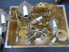 A crate containing three assorted continental light fittings, two with glass drops.