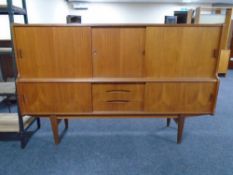 A mid-20th century teak sliding door high sideboard.