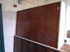 A mid-20th century painted double door sliding cupboard with teak doors.