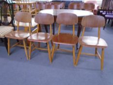 A set of four mid-20th century beech and plywood dining chairs.