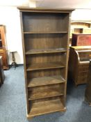 A set of oak open bookshelves.