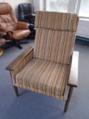A mid-20th century Scandinavian teak framed armchair upholstered in a brown and beige striped