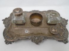 A silver plated on copper antique desk stand with inkwells.