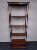 A mahogany four tier open display stand fitted a drawer