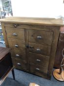 A pine double door storage cupboard in the form of a chest