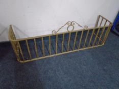 A painted wrought iron fire curb.