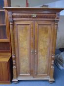A 19th century mahogany and walnut double door cabinet on bun feet fitted a drawer 144 cm x 91 cm x