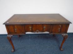 A Georgian style mahogany writing table with leather-inset panel fitted three drawers