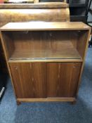 A mid-20th century teak sliding door bookcase.