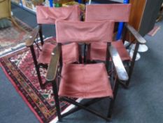 A set of three stained pine director's chairs