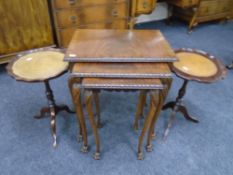 A nest of three mahogany tables on paw feet together with two wine tables
