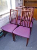 A set of six rail back dining chairs in mahogany finish.