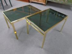 A pair of brass and smoked glass coffee tables.