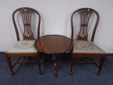 A pair of reproduction mahogany dining chairs together with a pie crust-edge occasional table