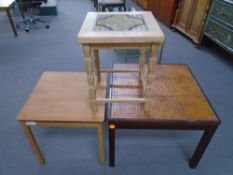 A blonde oak tile topped lamp table together with two further coffee tables.