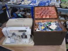 A New Home electric sewing machine in case with pedal and instructions together with a fabric