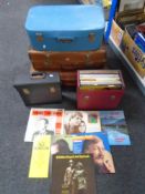 Three vintage luggage cases together with two cases of vinyl records