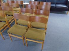 A set of eight mid-20th century teak and plywood dining chairs.