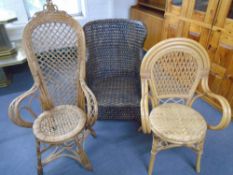 Three bamboo and wicker armchairs.