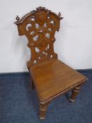 An Edwardian oak hall chair