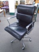 A Scandinavian black leather and chrome swivel desk armchair.