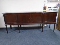 A reproduction mahogany four door sideboard