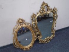 Two ornate gilt framed mirrors.