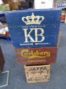 Three wooden crates bearing advertisements from Carlsberg, Kongens Bryghus and Jaffa.