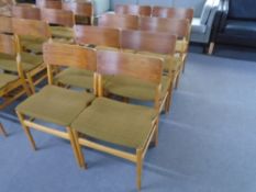 A set of eight mid-20th century teak and plywood dining chairs.