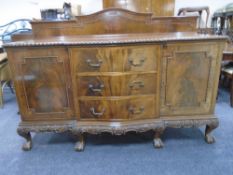 A late Victorian mahogany serpentine break-fronted double door sideboard on claw and ball feet