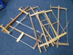 Six wooden Continental bow saws.