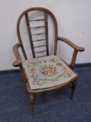 An Edwardian carved beech bergere armchair