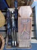 A box containing carved hardwood tribal figures together with a plant stand.