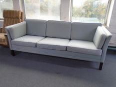 A 1970s Danish three seater settee upholstered in fabric.