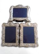 Three silver photograph frames.
