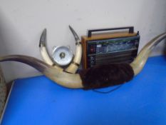 A Selena mid-20th century radio together with a pair of buffalo horns and a barometer plaque.