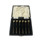 A set of six silver-gilt cocktail sticks, Walker & Hall, Birmingham 1951, with cockerel finials,