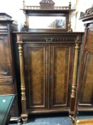 A 19th century mahogany and walnut cabinet with pillar column supports