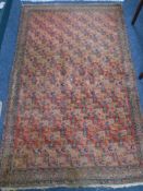 An Iranian rug with repeat boteh motif on red ground,