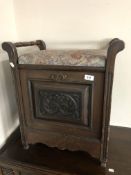An Edwardian storage piano seat containing sheet music and music books.