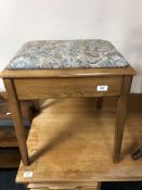 An upholstered storage piano stool containing sheet music.
