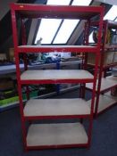 A five tier red metal shelving unit.