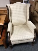 An Edwardian mahogany framed wingback armchair.